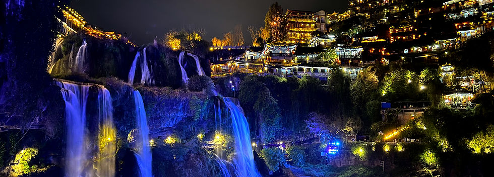 Nighttime view of waterfall at furong ancient town