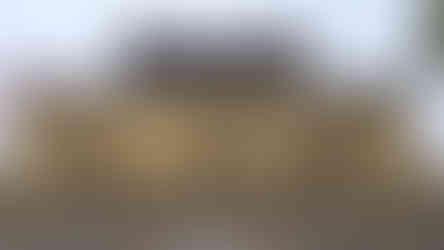 weathered citadel rampart, pointed roof and overcast skies