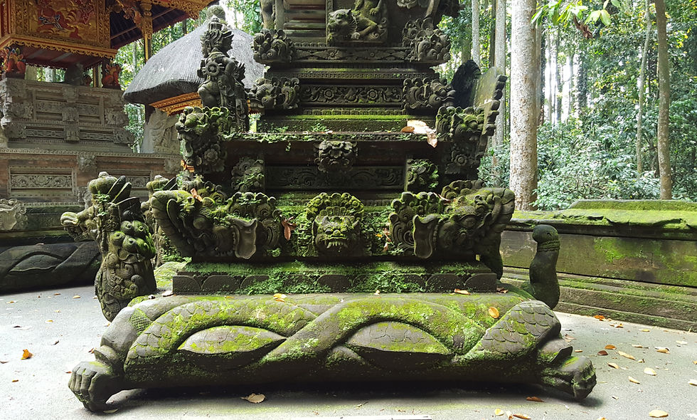 Moss-covered stone temple shrine with ornate carvings in a lush forest, weathered and serene.