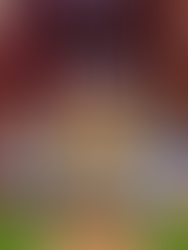 intricate carvings, offerings and candles surrounding a statue of the Buddha in a peaceful meditation pose, surrounded by multiple smaller buddha statues in gold, green and black