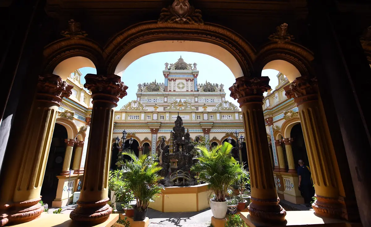 The ornate roofline of the internal courtyard at Vĩnh Tràng Pagoda, adorned with colorful tiles and intricate carvings, reflecting traditional Buddhist architectural style