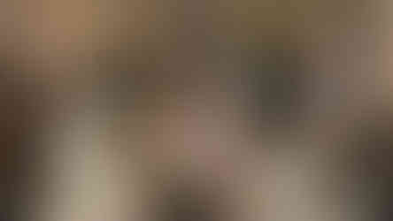 Museum exhibit of tribal masks and costumes displayed on mannequins and shelves. Wooden interior, colorful masks, and informational plaques.