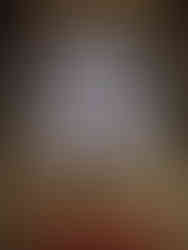 arched stained glass window, red altar with white candles in brass candlesticks