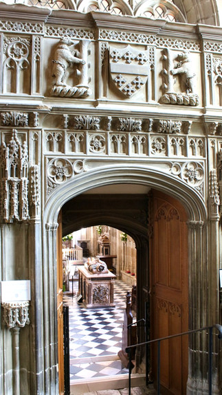ornate white archway with ornate depictions of christian themes