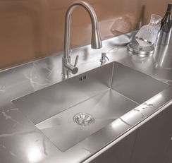 Flush integrated stainless steel sink and countertop with pull-down faucet, custom kitchen cabinet by Radiant Edge Design Singapore