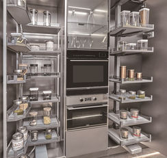 Pull-out pantry tower cabinet with organised multi-tier shelving, stainless steel kitchen by Radiant Edge Design Singapore