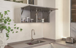 Lift-up wall cabinet above stainless steel sink with soft-close mechanism, custom kitchen by Radiant Edge Design Singapore