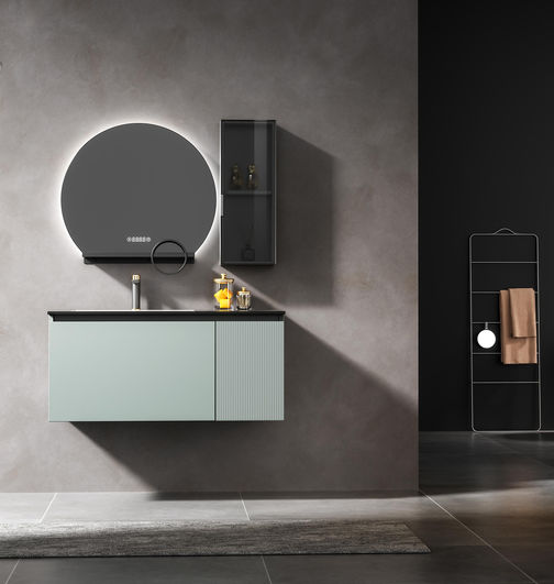 Full room view of mint sage green wall-hung vanity with circular smart LED mirror, smoked glass side cabinet and metal towel rack, custom bathroom cabinet by Radiant Edge Design Singapore