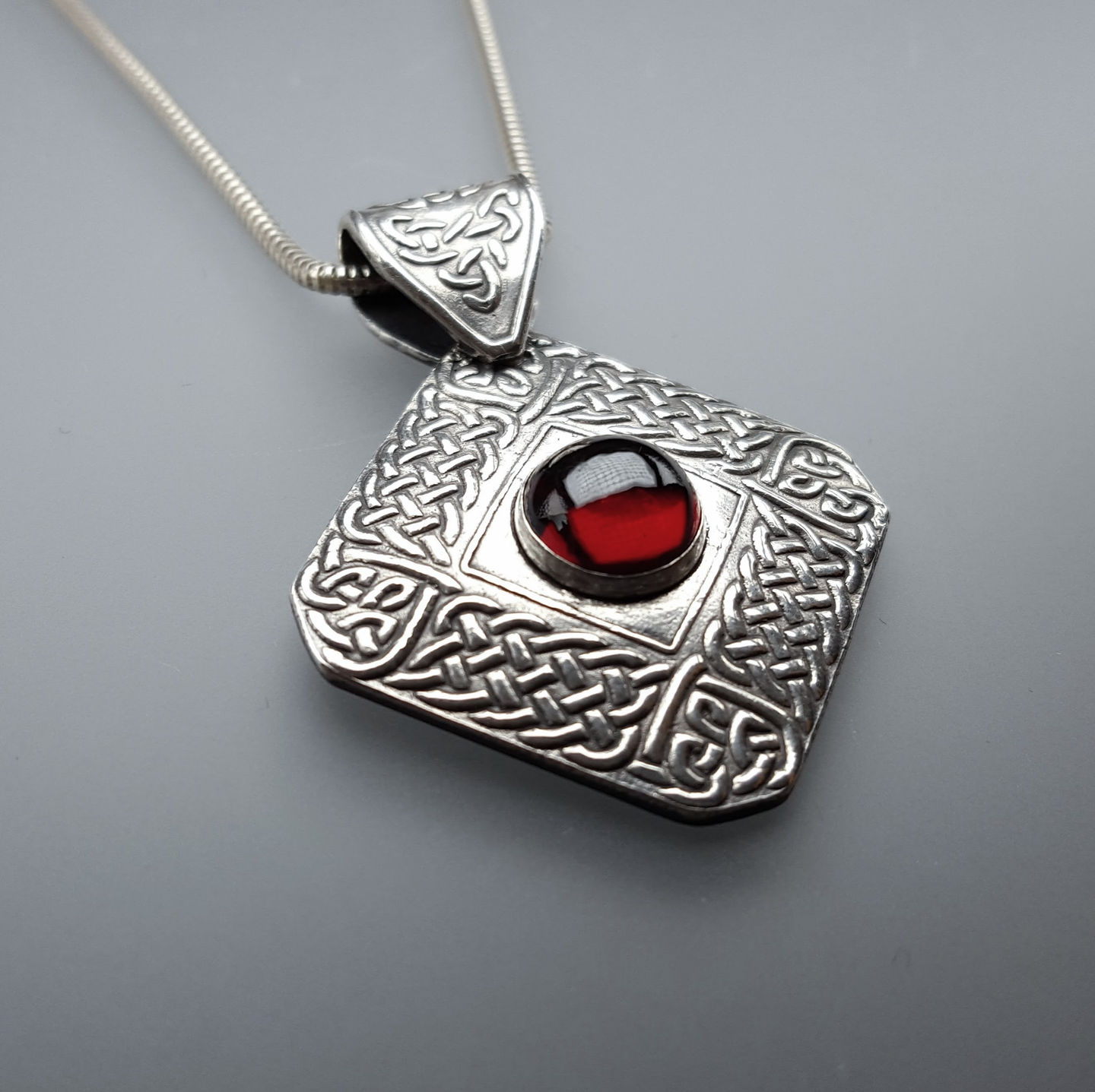 Celtic square with garnet