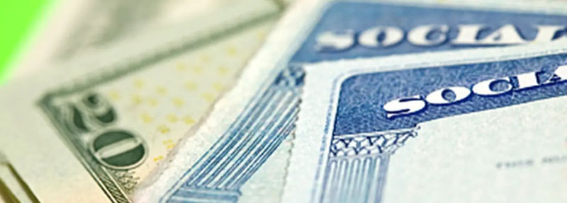 Social Security card next to dollars