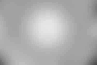 A black and white image of a dome ceiling with circular glass skylight.