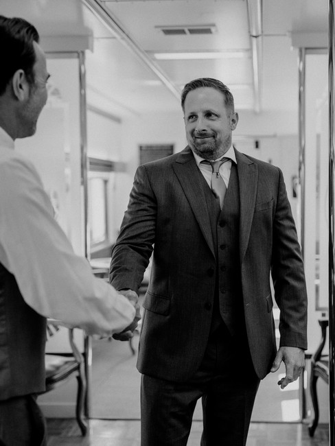 man shakes another man's hand