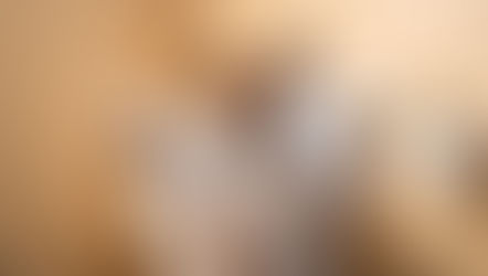 An Ai image of a puppy sitting on the toilet reading the news paper.