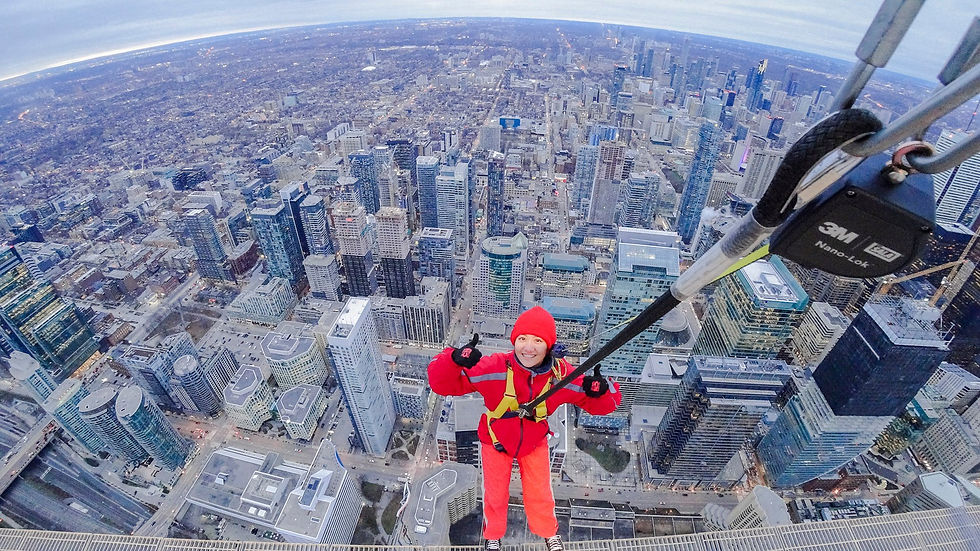 Girl posing for the hands-free EdgeWalk with Toronto's downtown buildings behind