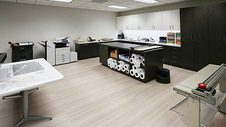 The centrally located work and reproduction area contains plotters and printers.