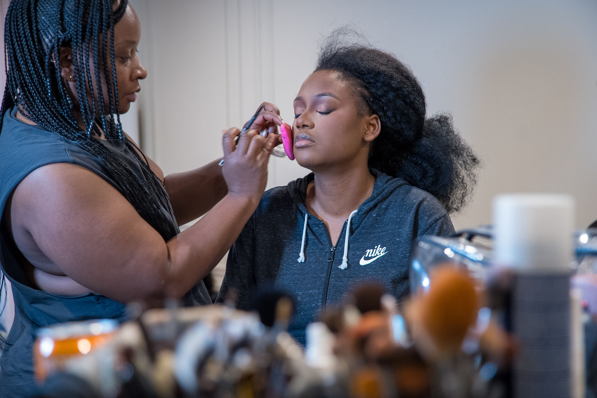 Bride having her makeup applied during her traditional wedding morning in Paris