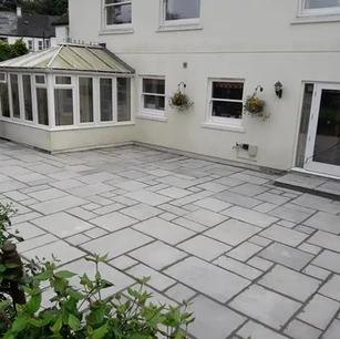 Light stone slabs laid for external patio space.webp
