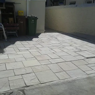 Stone slabs laid in front of house from the pavement
