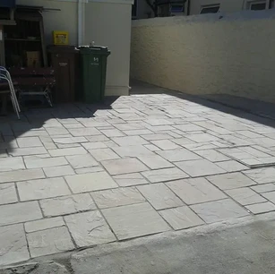 Stone slabs laid in front of house from the pavement
