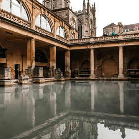 Ancient Roman Bath architecture with reflection in the water Bath Howe TreeConsultants