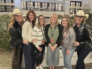 Jennifer Sadera with readers in cowboy hats at a book event