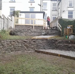 Stepped garden stone retaining walls and landscaping.webp