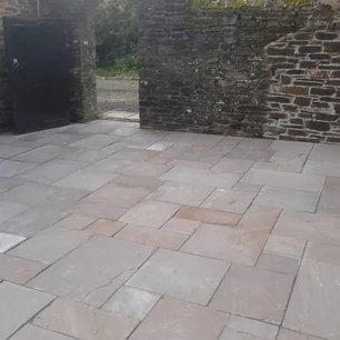 Courtyard with stone slab floor and stone walls.webp