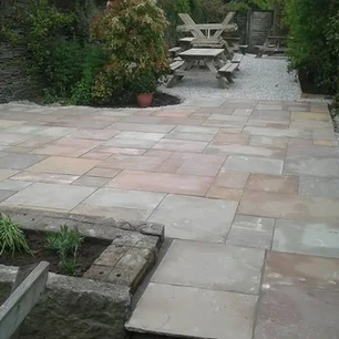 Stone slab laying in garden patio area.webp