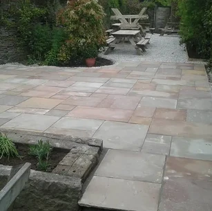 Stone slab laying in garden patio area.webp
