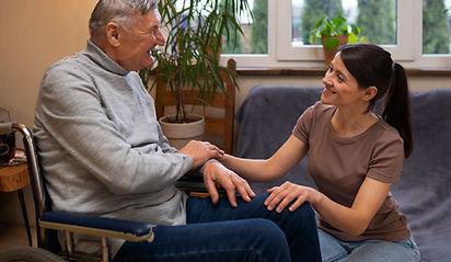 elderly-person-being-taken-care-by-female-caretaker.jpg