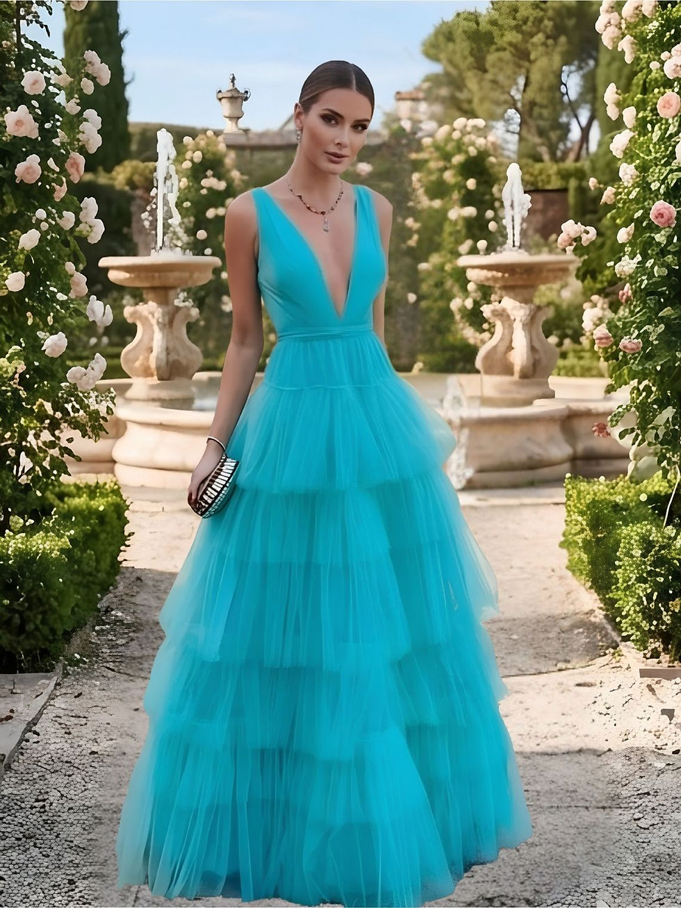 Woman in tiered turquoise gown at LomeroStudio garden