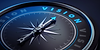 Compass with the needle pointing at the word Vision