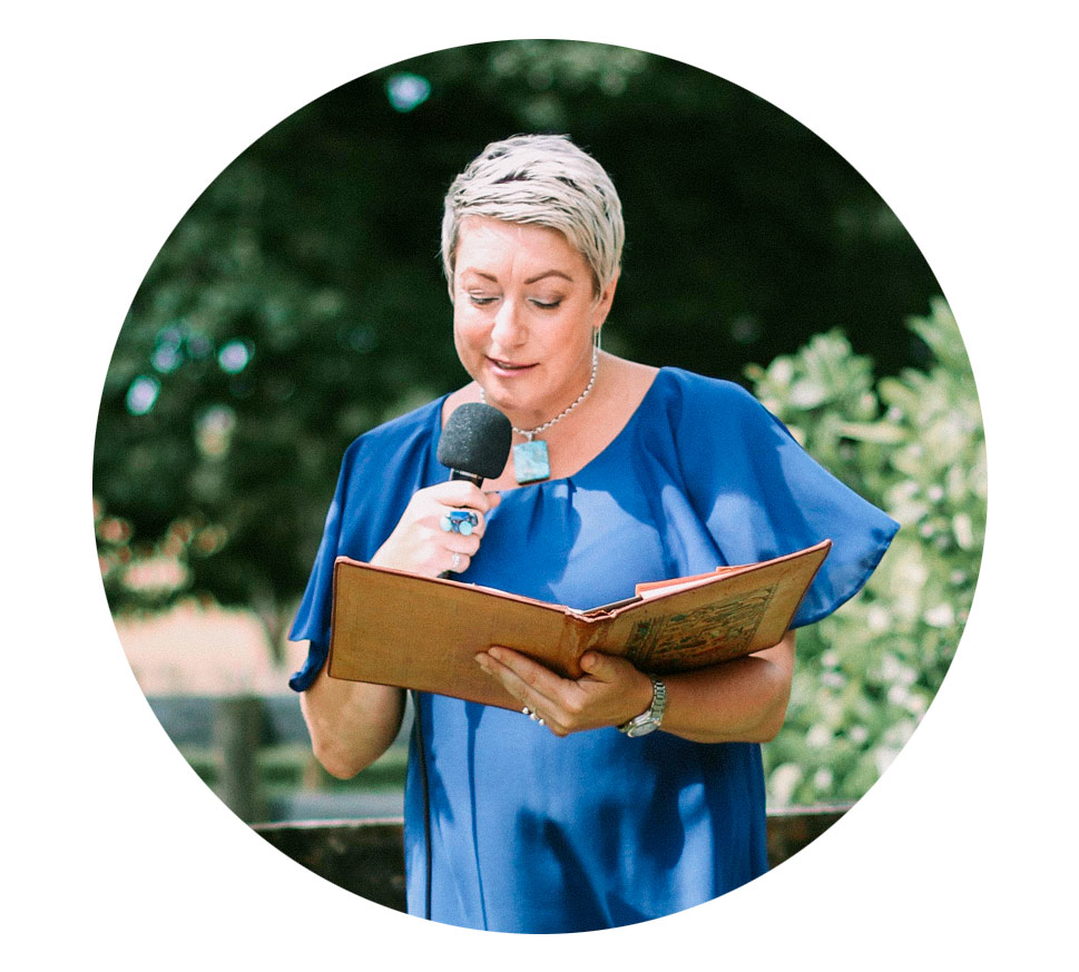Jan-Maree (Janny), a professional Hamilton wedding celebrant, officiating a ceremony while wearing a blue dress and holding a