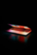 Colourful Laptop Screen Glowing against Dark Background