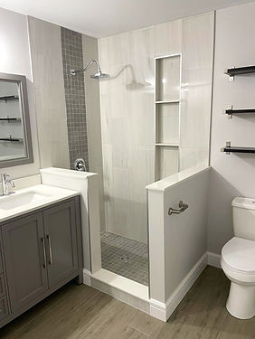 Custom tile shower with half walls and vertical niche