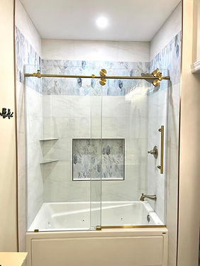 Custom shower, blue tile gold fixtures
