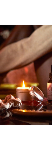 Urbane Hemp Box of woman sitting next to hemp candle as she start hair routine with hair oil  and comb 