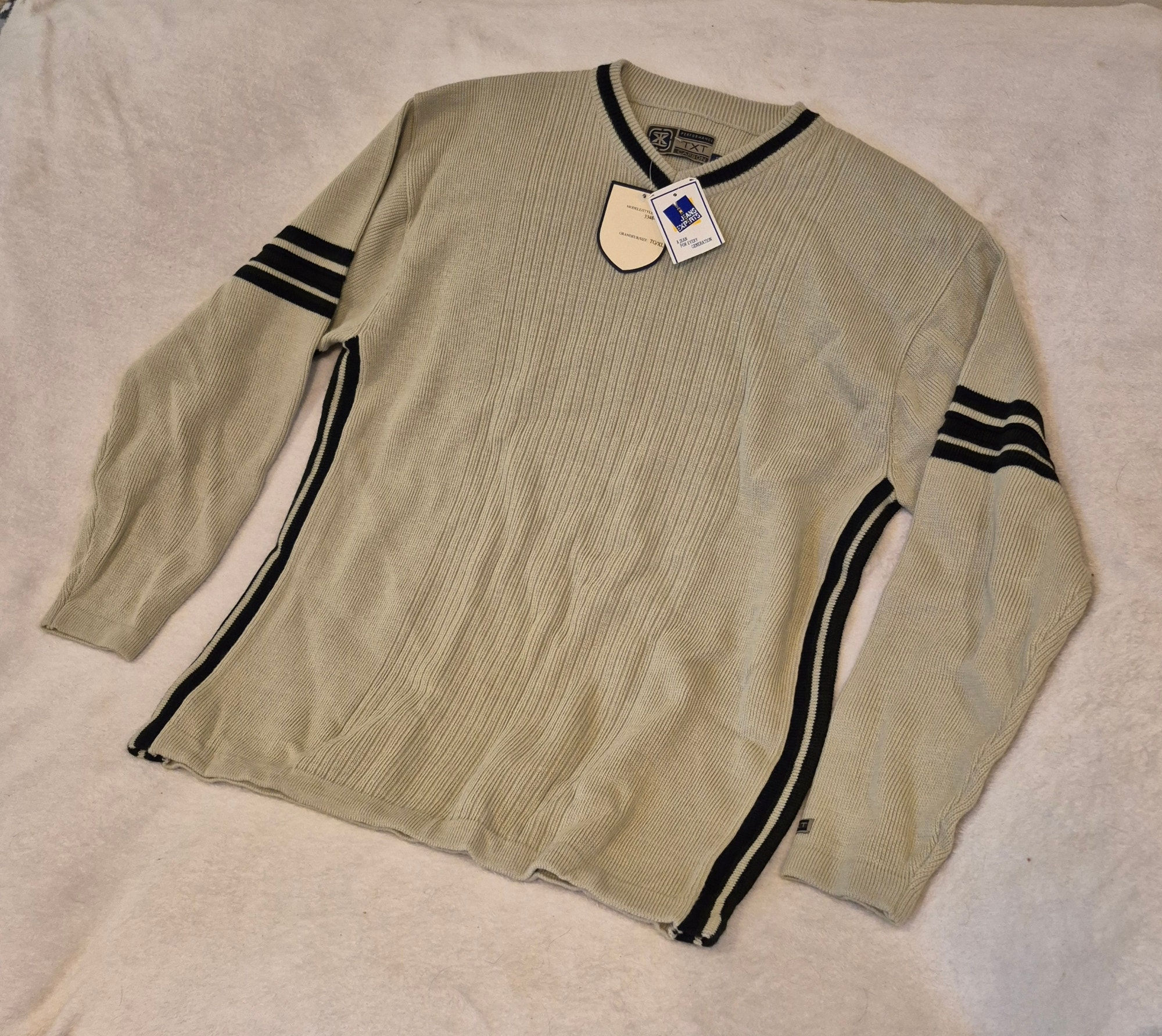 Light long-sleeve shirt with dark stripes and tags