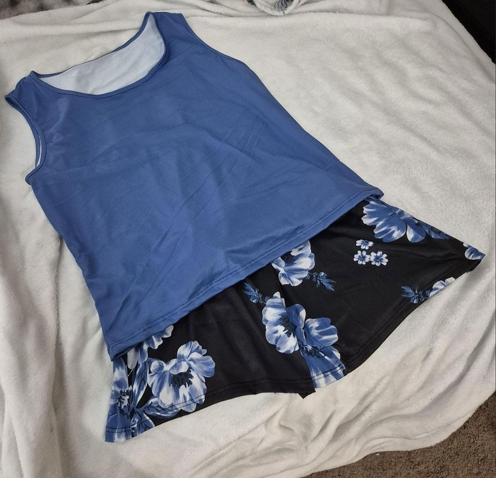 Blue sleeveless top with black and blue floral hem