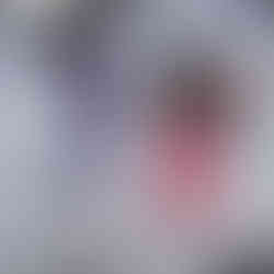 Kylie and her friend jumping with the ski hill behind them