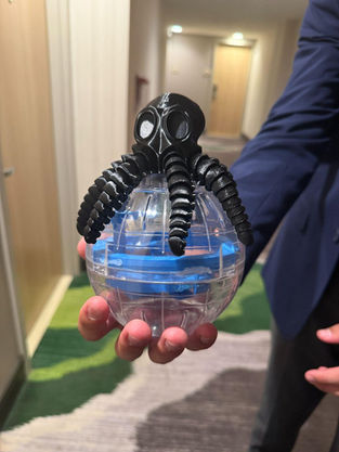 OctoFlow: a 3D-printed octopus hugging a clear marble maze sphere