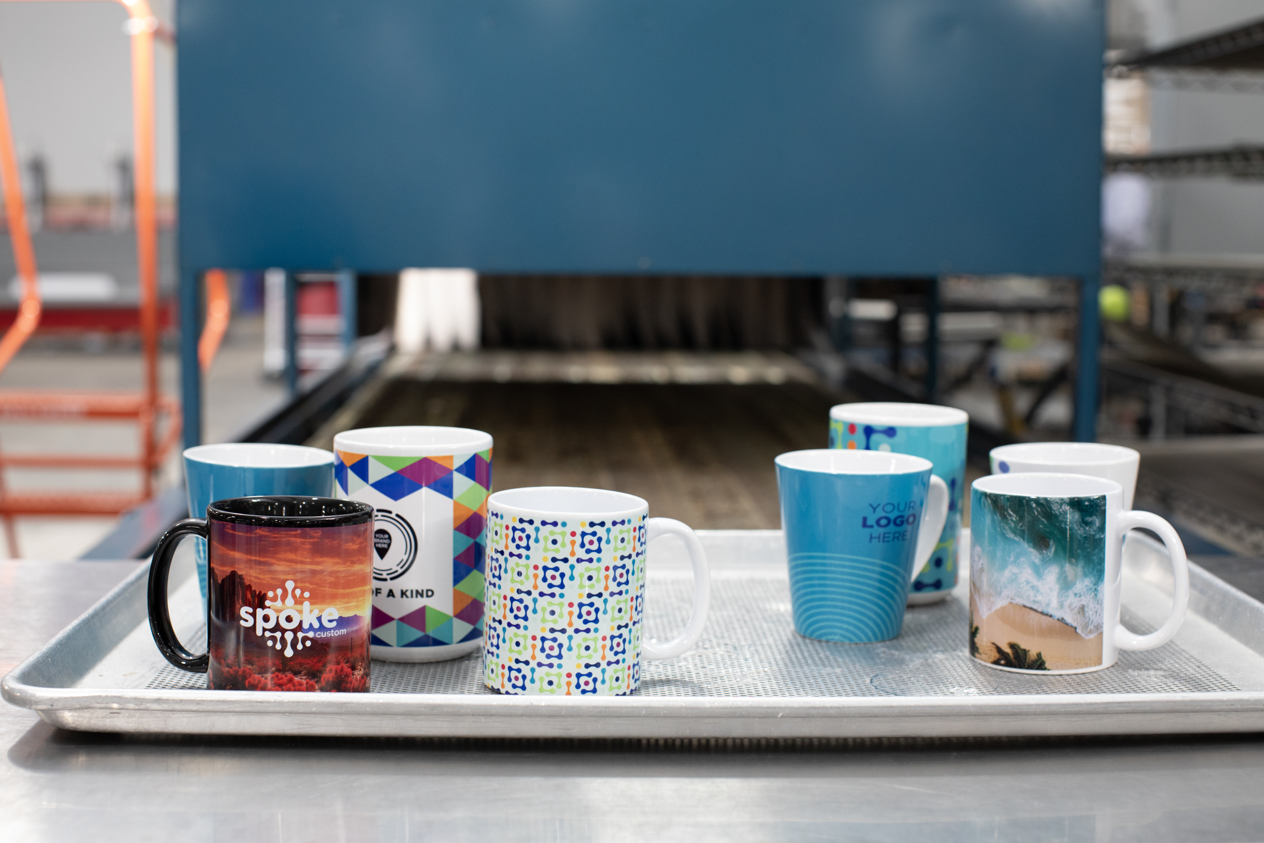 Spoke custom mugs on tray, fresh after printing