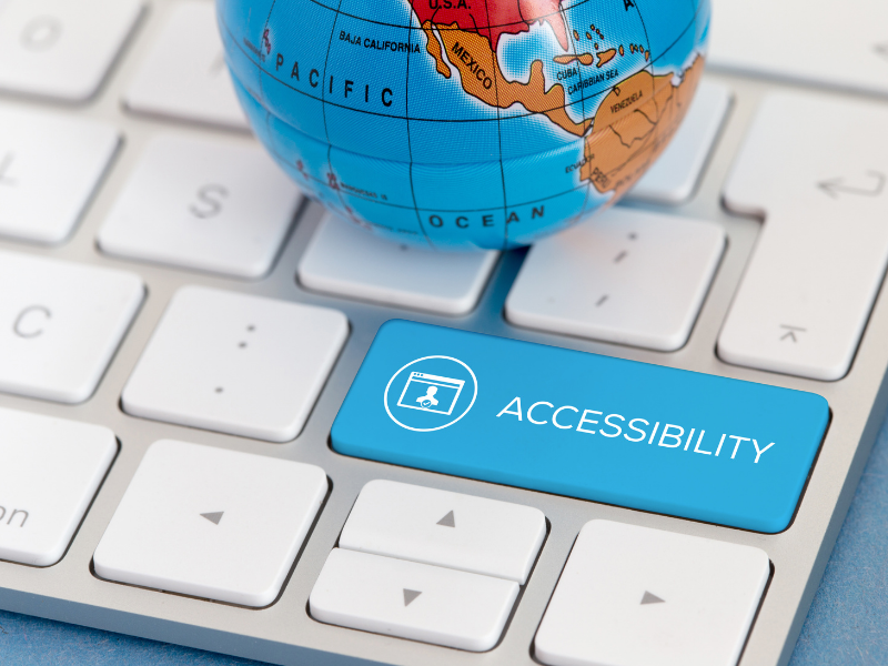 Keyboard with a zoom on the accessibility button while a world globe lays on top of the keyboard above the accessibility button.