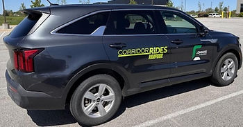 Dark gray SUV with CORRIDOR RIDES RAPID logo