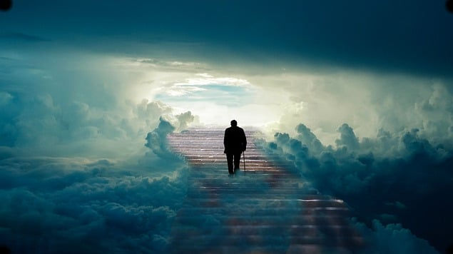 Man walking up the stairs with blue fogs and clear sky