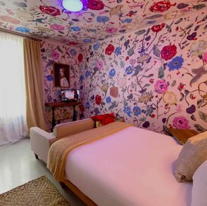 The whimsical rose room and art salon consists of four rooms, the least subtle of which holds this Apartment's namesake!
Full bed, dining room, kitchenette
