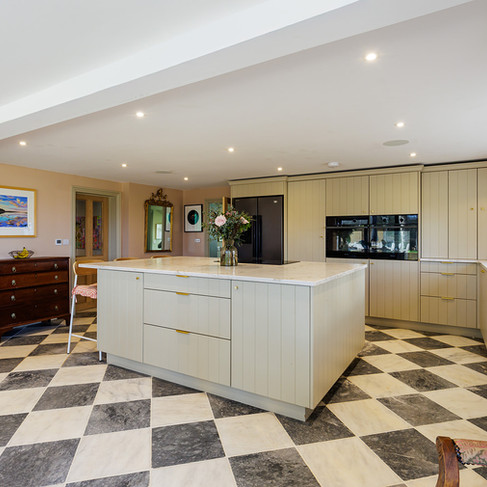 A Contemporary Country Kitchen in Petworth with Checkerboard Marble Floors and Dropcloth Cabinetry