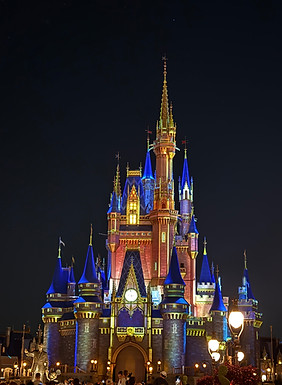 Cinderella Castle lit up at night at Magic Kingdom, Walt Disney World, on a family vacation planned by Kat Herman