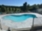 RenuKrete natural stone textured pool deck surrounding backyard swimming pool
