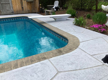 RenuKrete resurfaced pool deck in Granite Boulder showing deep gray granite tones in Allentown, PA